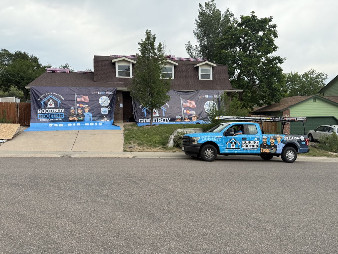 GoodBoy Roofing branded truck on a residential street in Denver