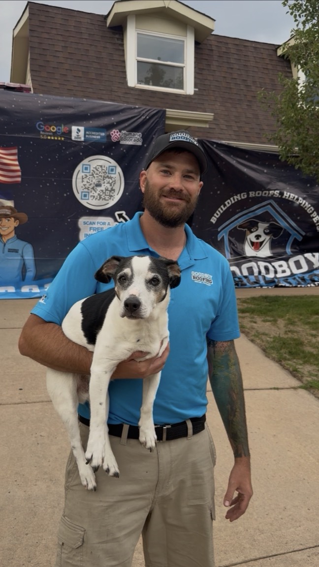 A GoodBoy Roofing team member with a rescue dog